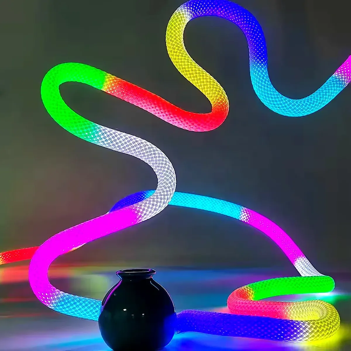 A lit 360-degree RGB neon flex profile formed into an S-curve that turns in more than one plane, glowing through its milky jacket