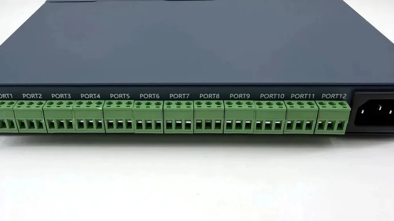 Twelve green output terminal blocks in a row along the front of an Art-Net and DMX pixel controller