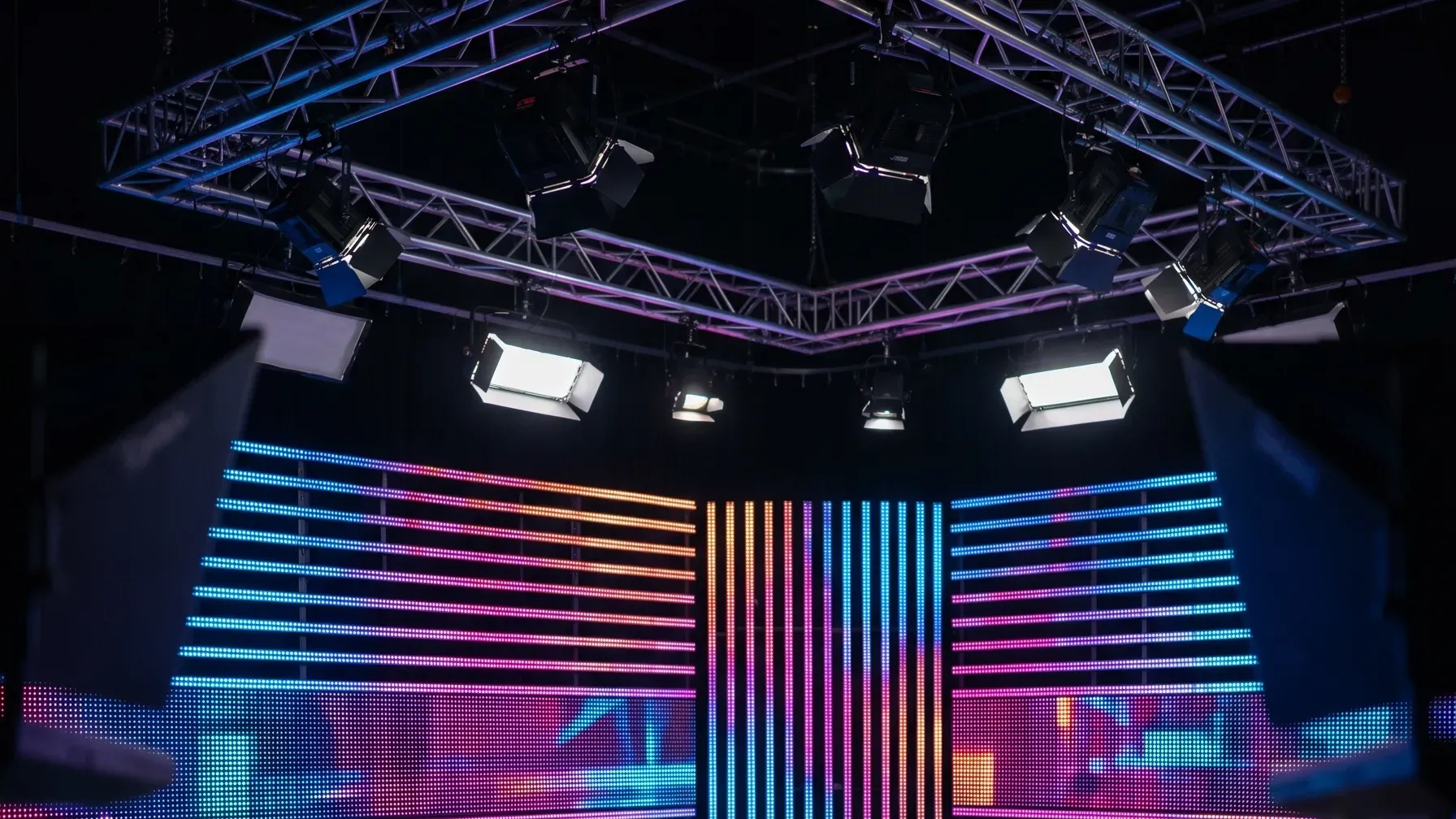 LED wall and truss lighting rig in an empty broadcast studio