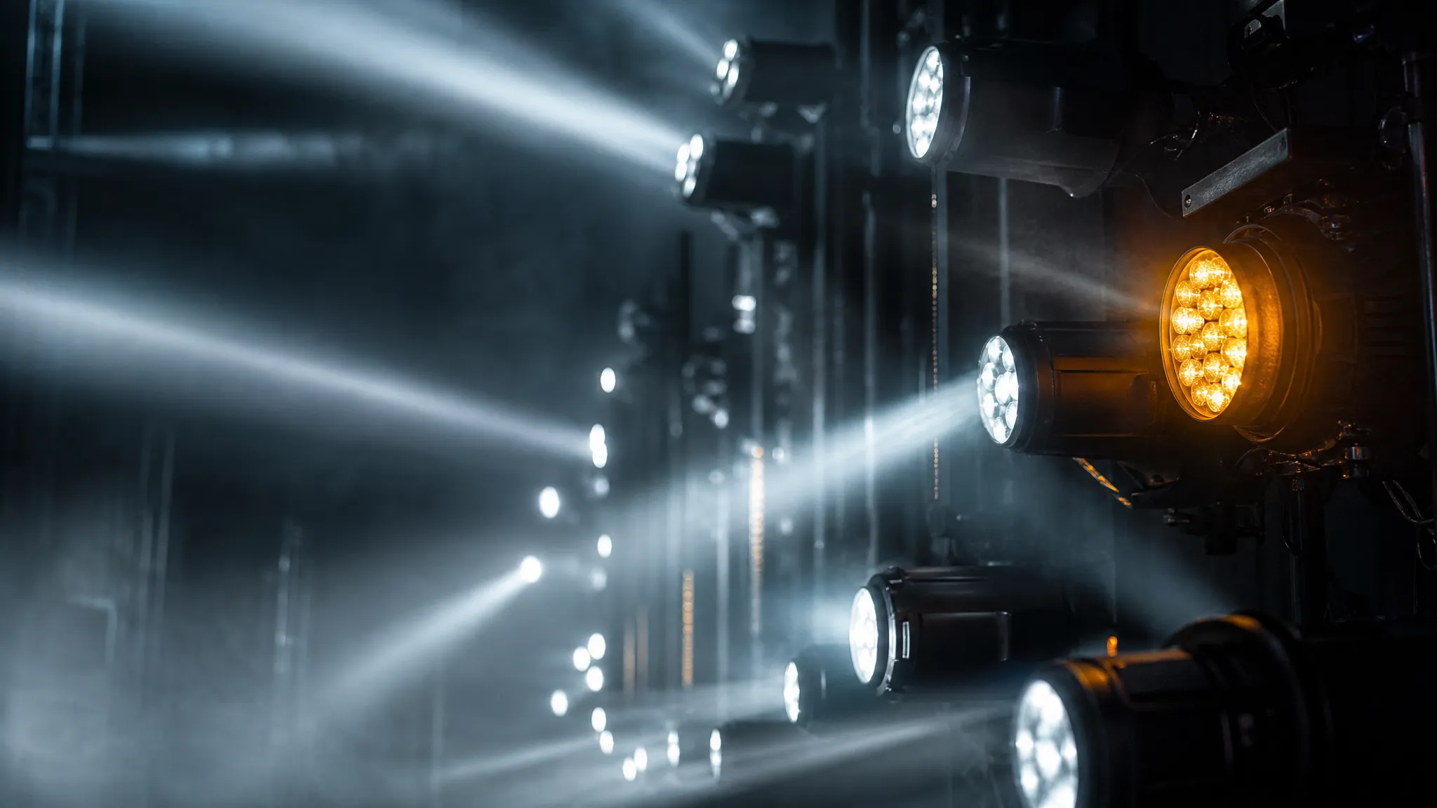 Fast-moving strobe and effect fixtures on a dark stage, the kind of cue where added link latency becomes visible to the audience