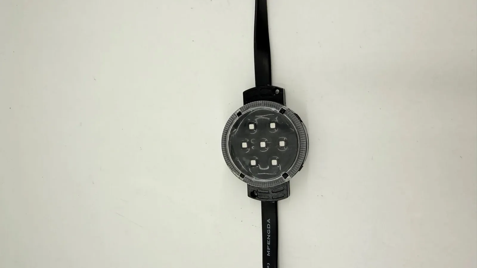Front view of a sealed round LED point light node with its clear lens and moulded cable tail