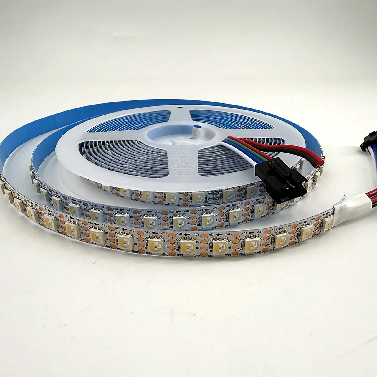 SK6812 RGBW addressable LED strip on a reel, four-channel RGBW chip visible under the silicone sleeve